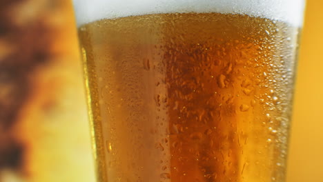 Beer-closeup.-Pint-of-cold-Craft-beer-isolated-on-matte-black-background-rotation-360-degrees.-Glass-of-beer-with-water-drops.