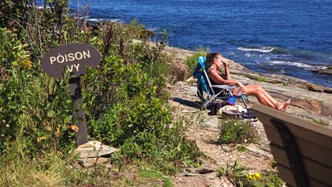 a woman suns herself near poison ivy at two lights state park