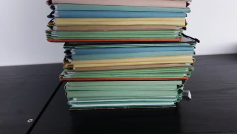 camera movement along a file shelf. the files are old, the paper is yellowed.