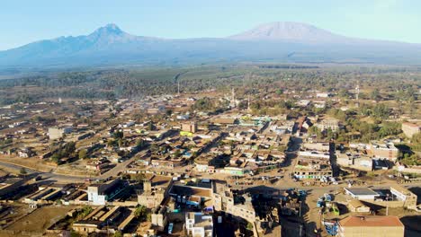 Sonnenaufgang-–-Kenia-Landschaft-Mit-Einem-Dorf,-Kilimandscharo-Und-Amboseli-Nationalpark-–-Verfolgung,-Drohnen-Luftaufnahme