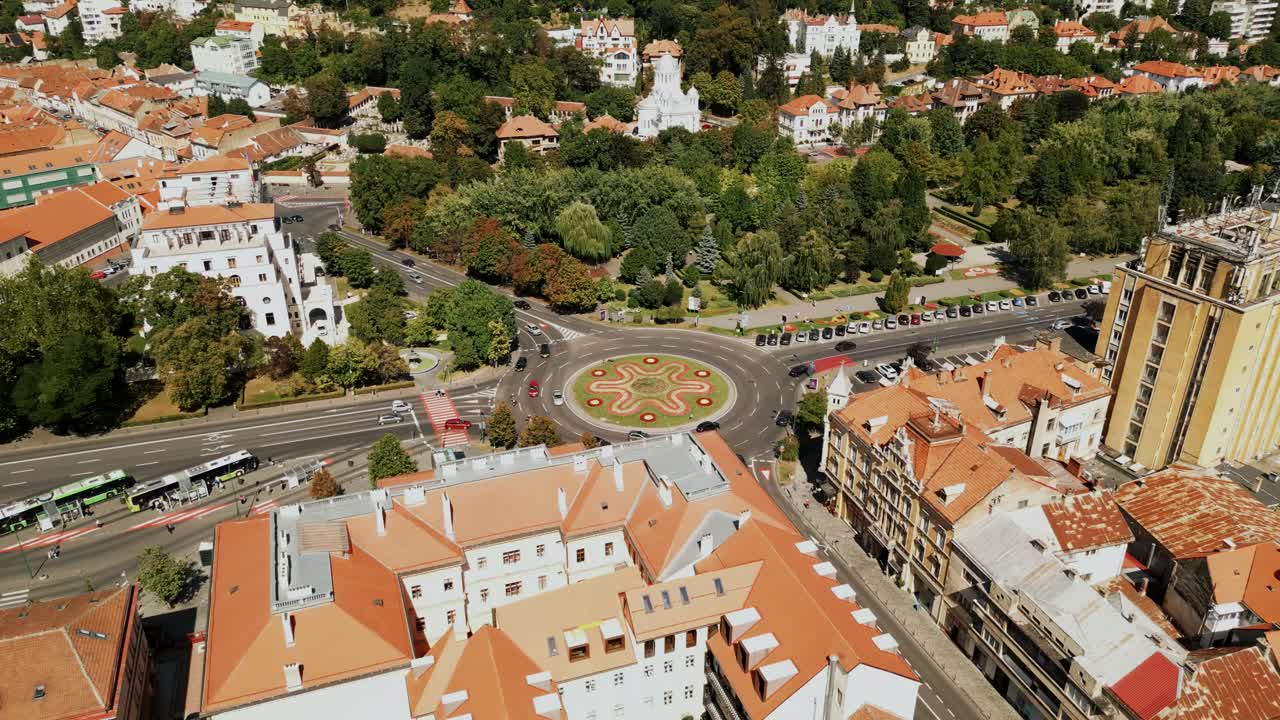Aerial View Of A Busy Roundabout With Flowerbed In The City Of Brasov, Transylvania Region In Romania