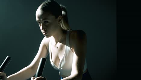 Rapid camera motion starting with a frontal closeup on a woman’s face and chest, quickly pulling back and rotating to profile, revealing her full body cycling with cinematic backlight and precision