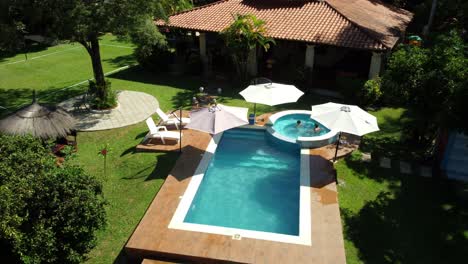 kids enjoying happily warm water in stunning pool design during summer, paraguay