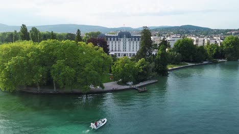 lakefront hotel with boat and trees