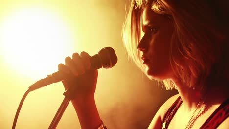 female singer singing into a microphone 4k