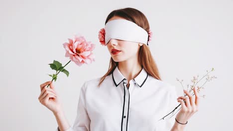 blindfolded woman experiencing flowers