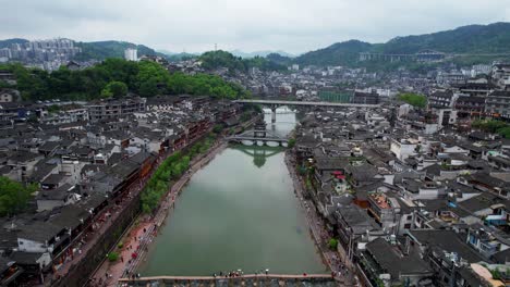 Stepping-Stones,-Wooden-Bridge-and-Snow-Bridge-along-Tuo-Jiang-in-Fenghuang,-China