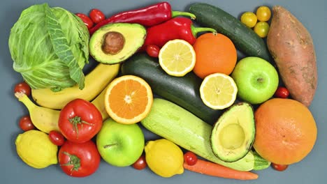 kitchen table full with fresh ripe and organic fruits and vegetables appear. stop motion flat lay