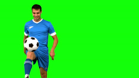 man playing with a football on green screen
