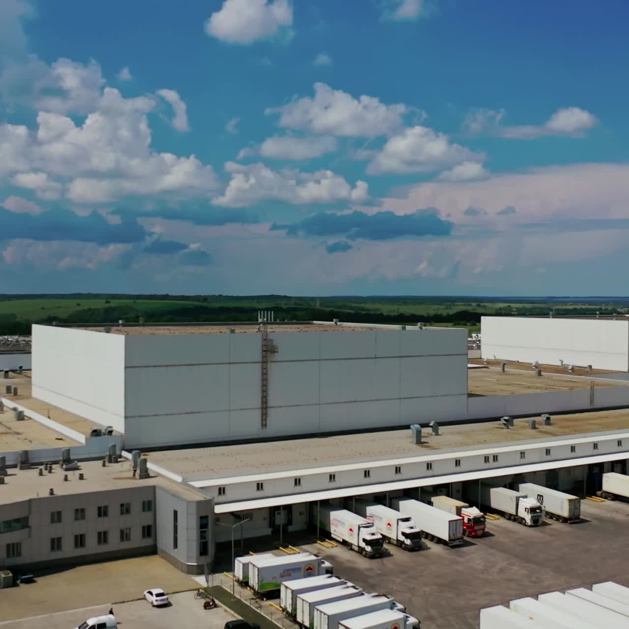 Large industrial area in nature. Exterior of manufacturing with modern architecture on natural landscape in summer. Camera rising up.