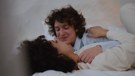 happy couple talking on bed