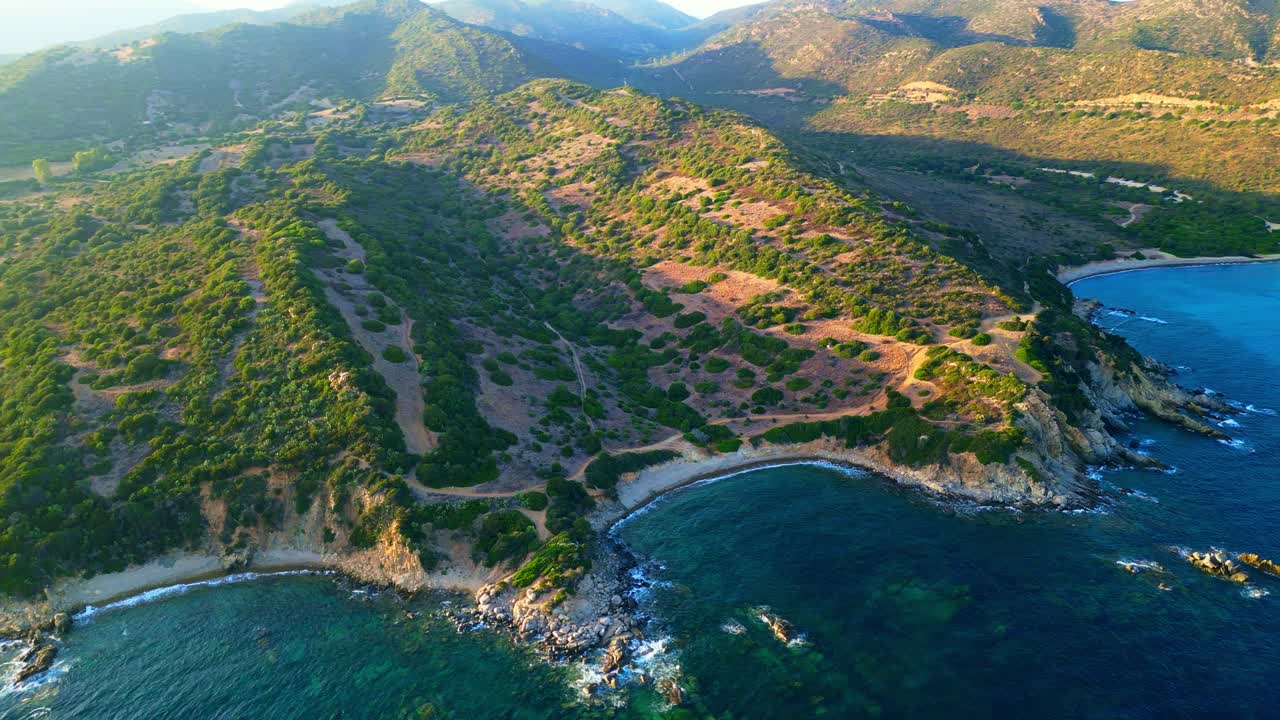 Picturesque Sardinian coastline of ocean water and hilly landscape
