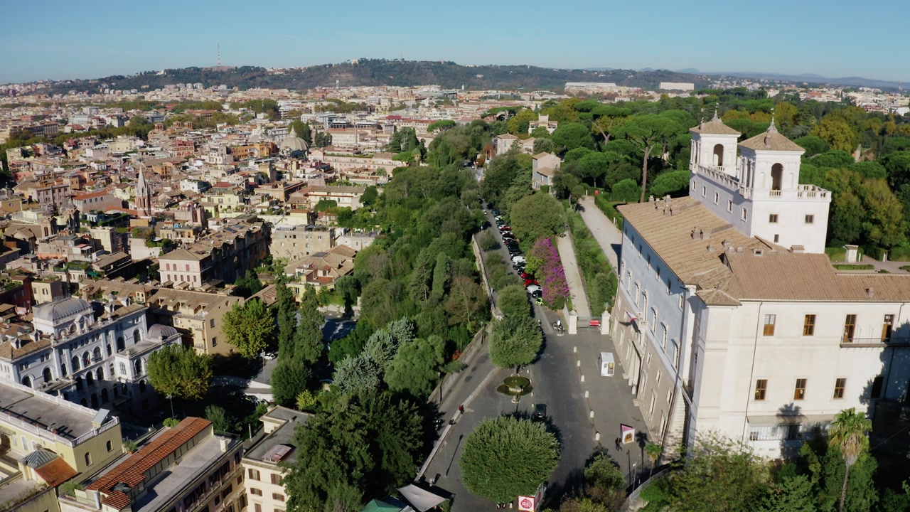 Aerial Drone Shot Over Rome Residential District with Green Park and Curving Avenue, Expansive Panorama of the Italian Capital City Landscape. UNESCO World Heritage Site with Renaissance Charm.