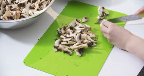 slicing fresh mushrooms