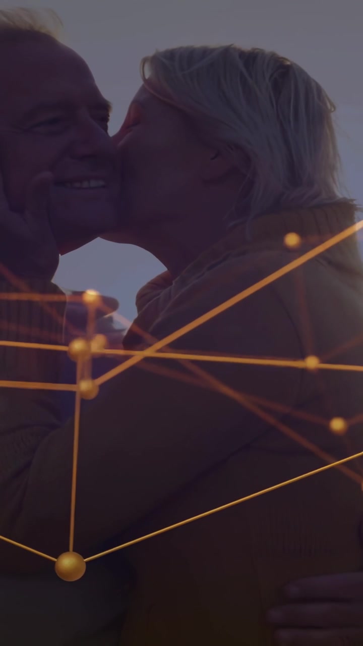 Couple at sunset woman reaching cupping man's face kissing loving tech nodes drifting over faces