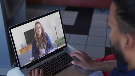 African-american-businessman-using-laptop-having-video-call-with-female-colleague