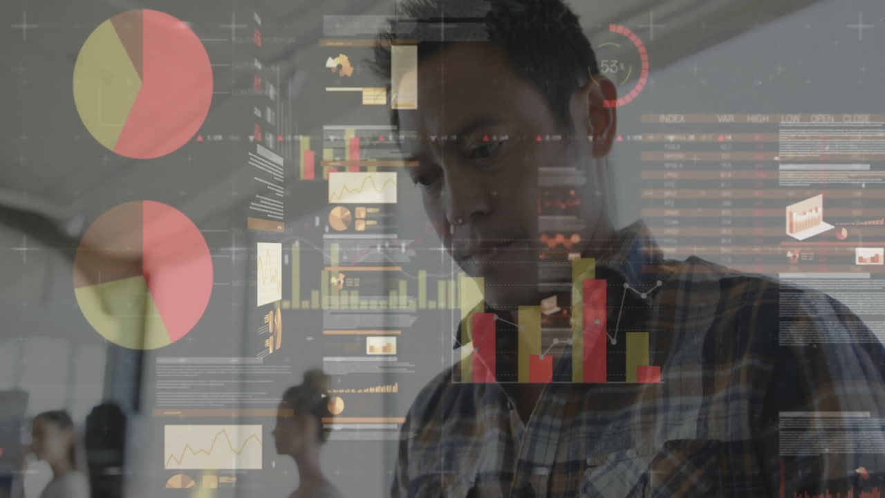Data analyst examining holographic charts in open-plan office, showing interactive tech graphics