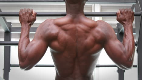 Man-doing-pull-ups-at-crossfit-gym