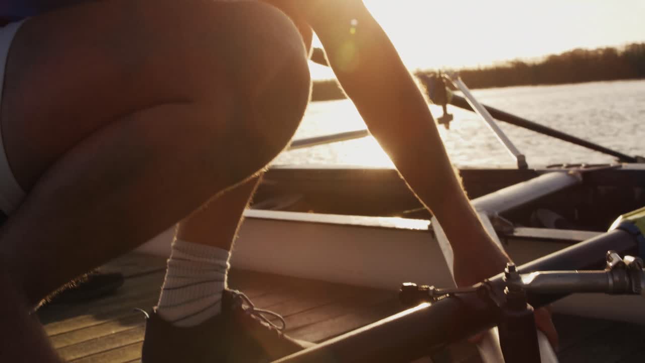 Male rower preparing boat before practice