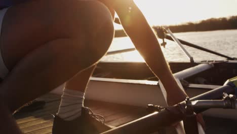Male rower preparing boat before practice