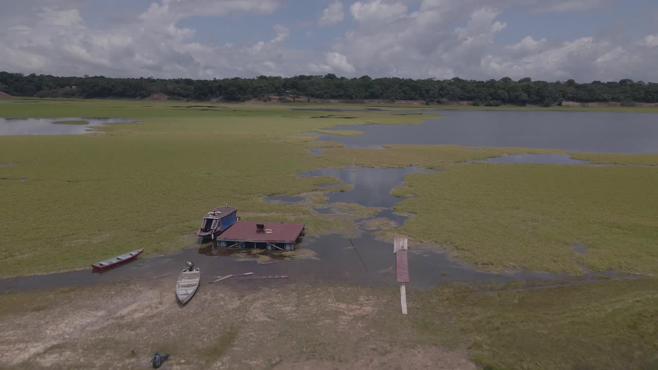 Rio Negro Amazon River - Capim grass and boats - push in aerial drone shot