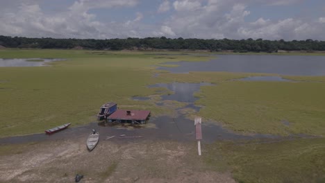rio negro amazon river - capim grass and boats - push in aerial drone shot