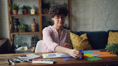 woman creating a paper collage