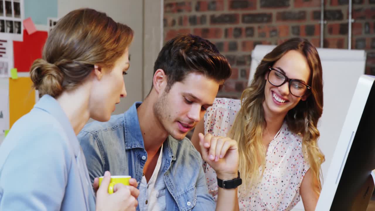 grupo de diseñadores gráficos interactuando a través de una tableta gráfica y una computadora