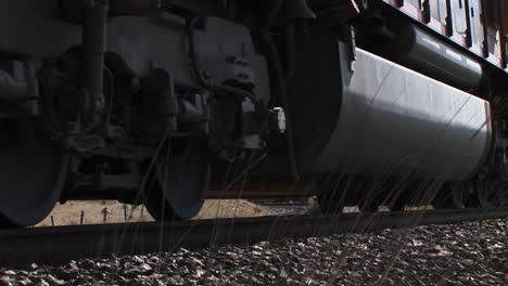 Close-Up-Of-A-Train-Passing-On-Tracks-In-The-Desert