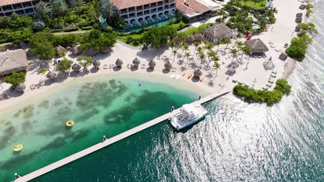 aerial bird's eye view around tropical beach in curacao with resort umbrellas and amenities