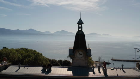 aerial dolly of clock tower overlooking lake geneva in switzerland