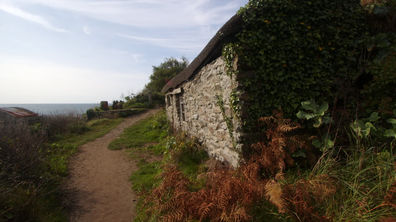 Mid shot looking up at old fisherman's cottage at Bessy's Cove, The Enys , cornwall