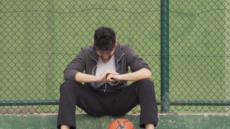 being excluded. young man alone is crying.