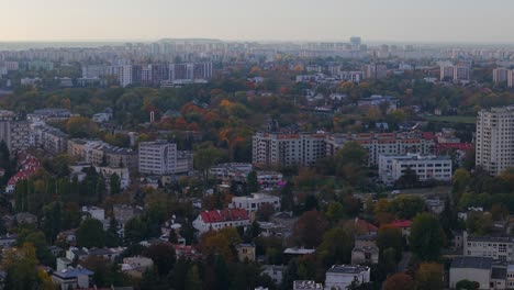 aerial view of warsaw poland residential neighborhood in autumn twilight, flying above old and modern buildings