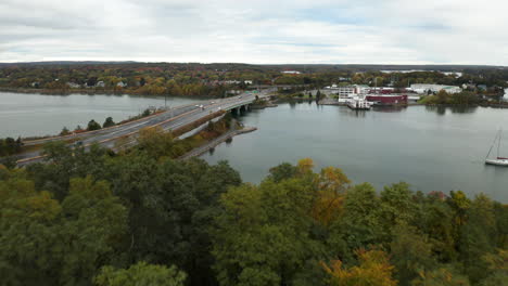 gorgeous aerial flyover shot revealing the i-295 highway over the treetops in the east end of portland, maine