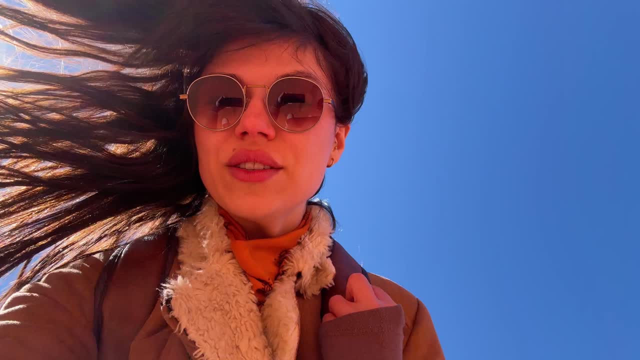 Happy Woman Taking Selfie Video in Desert with Red Rock Formations