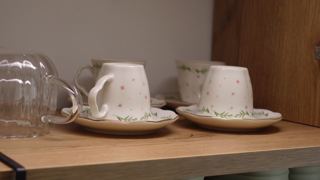 Clean White Teacups and Saucers Stored in a Kitchen Cabinet