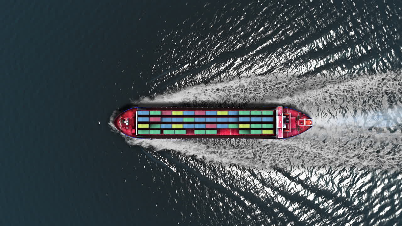 Aerial View of a Cargo Ship with Containers Moving Through Water