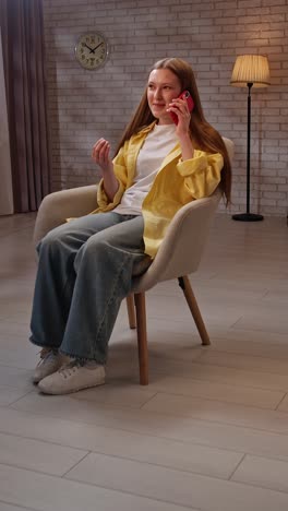 teenage girl talking on phone in a living room