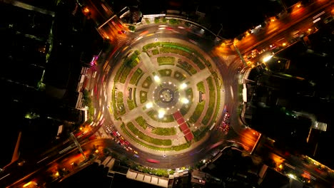 time lapse of wongwian yai roundabout. aerial view of highway junctions. roads shape circle in architecture and technology transportation concept. top view. urban city, bangkok at night, thailand.