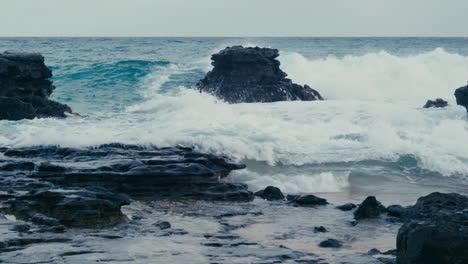 waves crashing on volcanic rock in hawaii