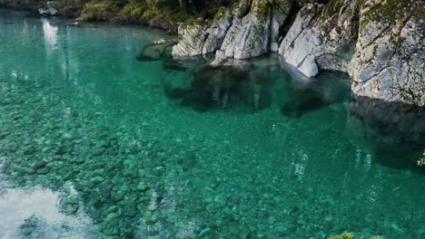 tranquil clear blue river on greenstone caples track, new zealand