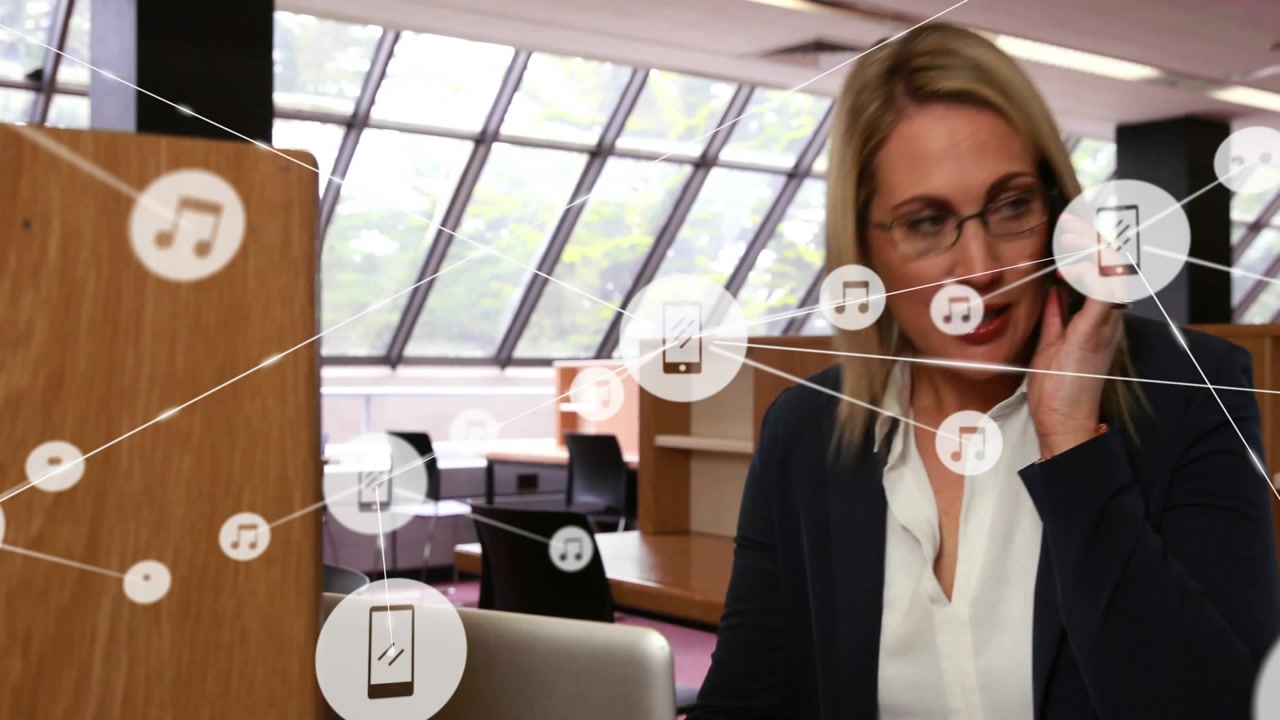 Businesswoman talking on smartphone in modern office, showing floating music note and phone icons