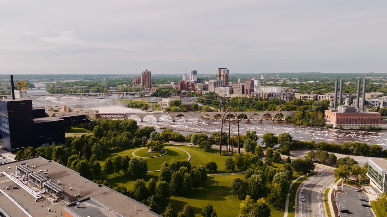 An aerial drone shot in Minneapolis of Gold Medal Park, the Stone Arch Bridge and the Mississippi in Minnesota