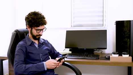 latin man making a call in office at home