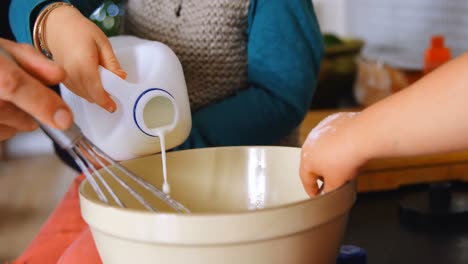 father and children pouring and stirring milk 4k