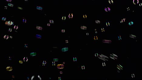 colorful soap bubbles fly out on the right side black background lot of bright colorful soap bubbles fly into the air on the right side black background