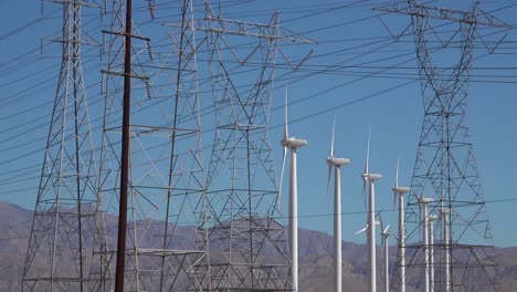 Wind-turbines-spin-in-the-desert-near-power-lines-and-poles-Mojave-desert-Palm-Springs-California