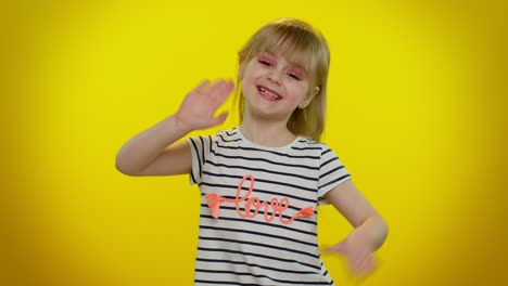 Little-blonde-child-kid-girl-waves-hand-palm-in-hello-gesture-welcomes-someone,-positive-emotions