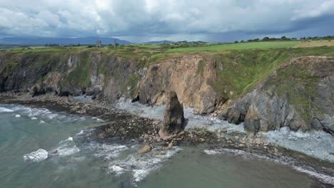 An-Einem-Stürmischen-Sommertag-Wird-Es-Von-Den-Jüngsten-Steinschlägen-Auf-Der-Klippe-Dahinter-Und-Den-Düsteren-Wolken,-Die-Von-Den-Comeragh-Bergen-Dahinter-Heraufziehen,-Seekrank